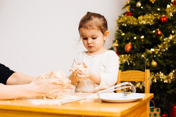 Toddler girl helping make christmas pastry