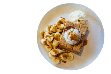 Close-up on, Honey Toast, bread buttered toast, banana, ice cream and whipped cream dessert on a white dish with clipping path