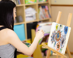 Artist painting oil painting on an easel