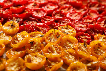 Sun dried tomatoes, dried red and yellow cherry tomatoes, close up. Sun dried tomato background.