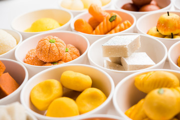 Rangoli of Assorted Indian sweets/mithai in bowl for Diwali or any other festivals, selective focus