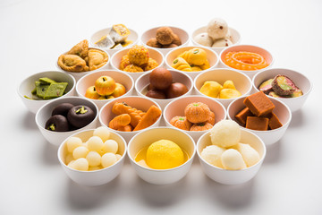 Rangoli of Assorted Indian sweets/mithai in bowl for Diwali or any other festivals, selective focus