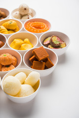 Rangoli of Assorted Indian sweets/mithai in bowl for Diwali or any other festivals, selective focus