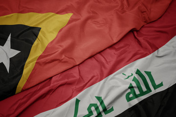 waving colorful flag of iraq and national flag of east timor.