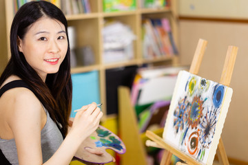 Artist painting oil painting on an easel