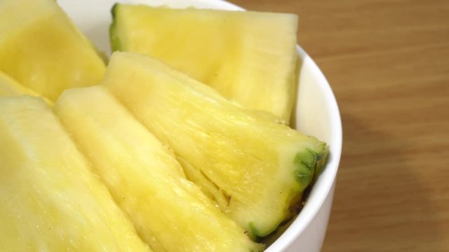 Pi&ntilde;a cortada en trozos en un bol de cer&aacute;mica