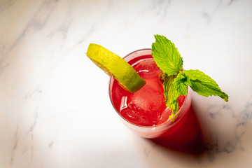Refreshing raspberry cocktail with crushed ice, mint and lime.