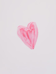 Hand drawn shape of the heart. Sample of pink lip gloss on a white background.