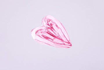 Hand drawn shape of the heart. Sample of pink lip gloss on a white background.