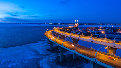 Russia. St. Petersburg in the evening. Western high-speed diameter. The Expressway passes over the bridge. Winter evening in St. Petersburg. Rivers Of St. Petersburg. The bridge across the river.