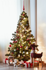 Christmas morning, gifts under the Christmas tree. Gift boxes tied with a red ribbon