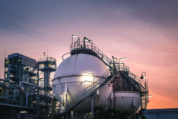 Gas storage sphere tanks in factories on sunset sky background - obrazy, fototapety, plakaty