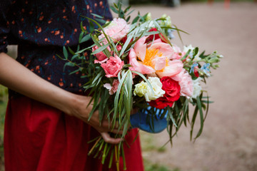 Florist girl collects a large beautiful bouquet. Floristic concept, business concept, gift, surprise, peonies, roses, carnations