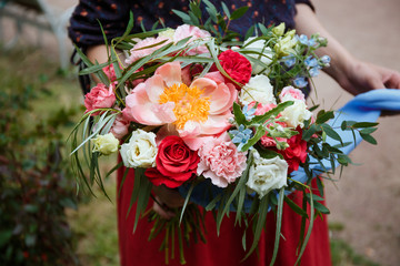 Florist girl collects a large beautiful bouquet. Floristic concept, business concept, gift, surprise, peonies, roses, carnations