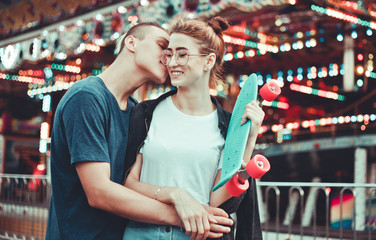 Obraz na płótnie Canvas Romantic concept. Beautiful, young couple in love having fun at amusement park.