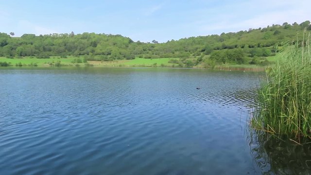 Landscape of Schalkenmehrener Maar lake in Eifel region of Germany. Volcanic crater landscape.