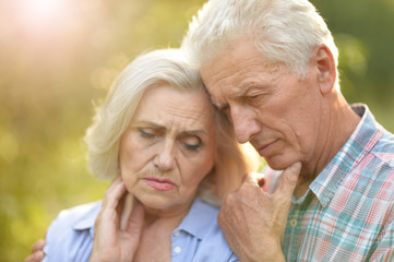 Portrait of unhappy senior couple in the park