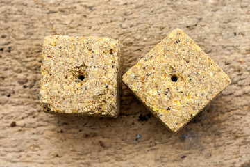 Pressed corn waste briquettes. It is used as feed for animals, birds and fish. One of the feed ingredients.