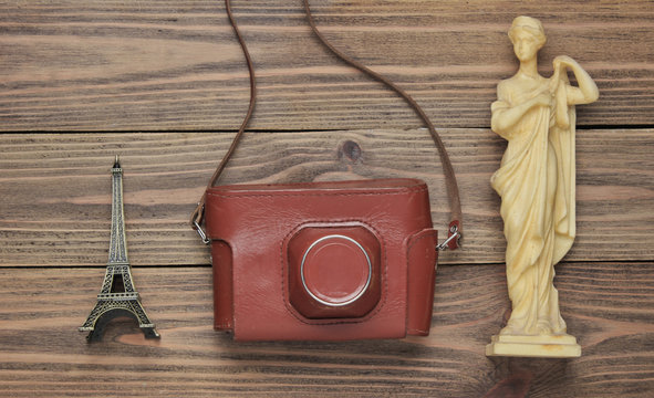 Tourism concept. Traveler background. Travel around the world, flat lay style. Souvenirs, retro camera on wooden background