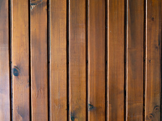 Dark varnished wooden planks wall texture. Rustic background