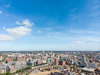 Fototapeta na wymiar Aerial photo of the British town of Leeds in West Yorkshire UK, showing the Leeds City Centre taken with with a drone on a bright sunny day in the town of Holbeck near to the centre.