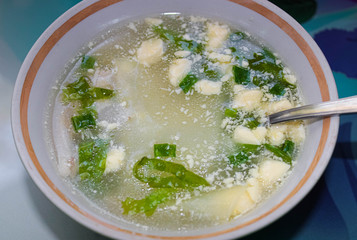 Meat soup in the plate with the mayonnaise and herbs.
