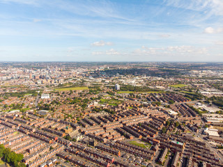 Aerial photo of the town known as Beeston in Leeds West Yorkshire UK, showing a rows of houses in a typical British housing estate taken with a drone on a bright sunny.
