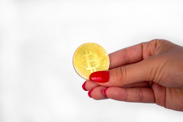 Fototapeta premium Bitcoin coin in woman's hand