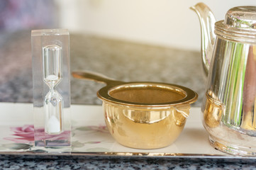 Hourglass timing with filter and tea set, tea break on afternoon.