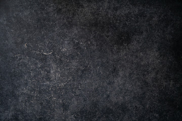 An old worn blackboard or chalkboard with doodle chalk. Dark background of retro textured surface. Abstract backdrop with vintage structure. Template with grunge effect for adding text and graphics.