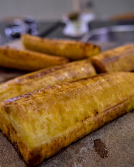 fried banana accompanied by guacamole, vegetables and meat