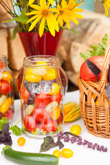Bouquet of flowers and basket with autumn crop of seasonal vegetables