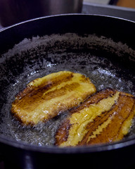 fried banana accompanied by guacamole, vegetables and meat