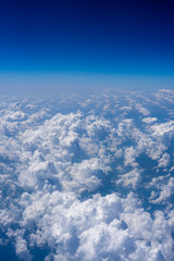 White clouds and blue sky, a view from airplane window