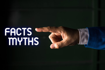 Handwriting text writing Facts Myths. Conceptual photo work based on imagination rather than on real life difference Isolated hand pointing with finger. Business concept pointing finger