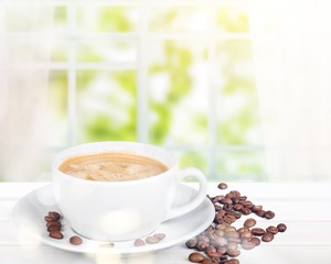 Coffee cup and coffee beans on  background