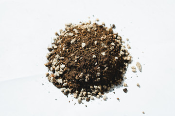 Closeup pile of soil and gravel on white background