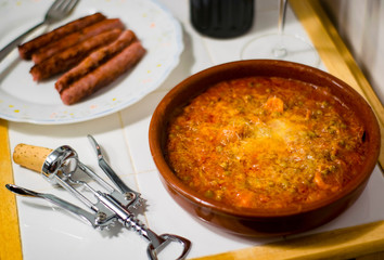 pea casserole with tomato sauce, wine and sausages