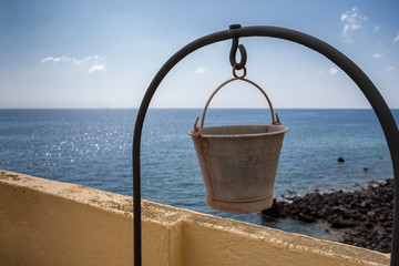 Naklejka premium Bucket on the well on the island of Salina in Sicily
