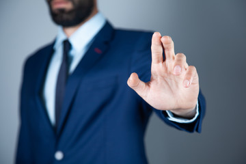 man finger in screen on gray background