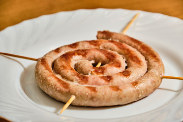 Spiral sausages on white plate