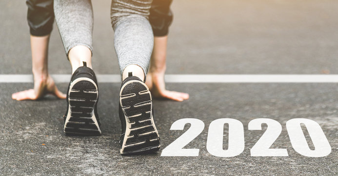 Woman in sports uniform running around. Healthy way of life, an infused figure. sneakers close-up, finish 2019. Start to new year 2020 plans, goals, objectives