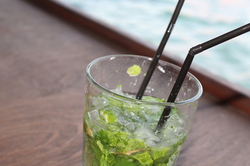 Mojito on the rocks. Summer, sea and alcohol on the background of the yacht.