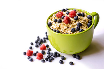Oatmeal and fresh berries isolated on a white background.