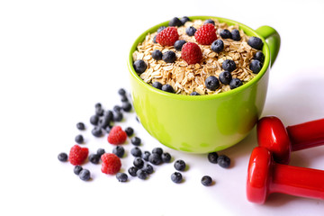 Oatmeal and fresh berries isolated on a white background.