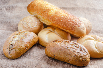 An assortment of fresh buns and spikelets on burlap.