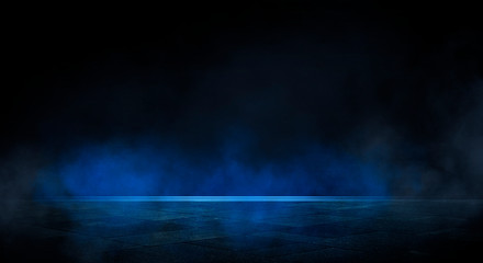 Blue dark background of empty foggy street with wet asphalt, illuminated by a searchlight, laser beams, smoke