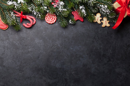 Christmas card with gingerbread cookies and fir tree