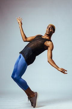 Portrait of a young man dancing en pointe in studio