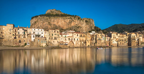 Fototapeta na wymiar View of the harbor and the old town of Cefalu, one of the most beautiful places in Italy.